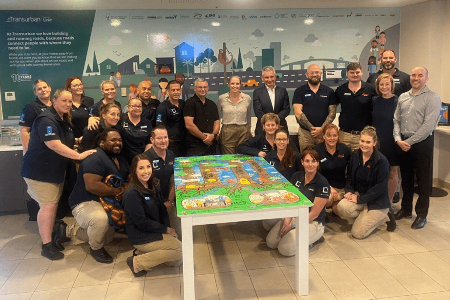 Amart staff at RMHC SEQ with donated table